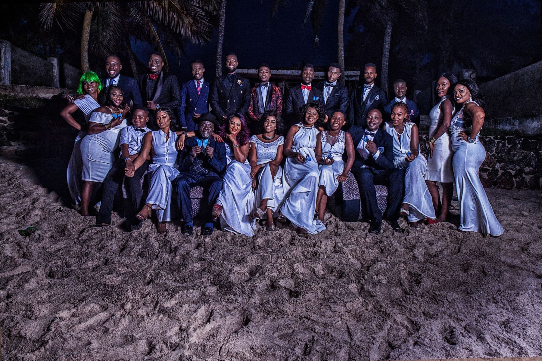 The wider cast gathered on a beach at night
