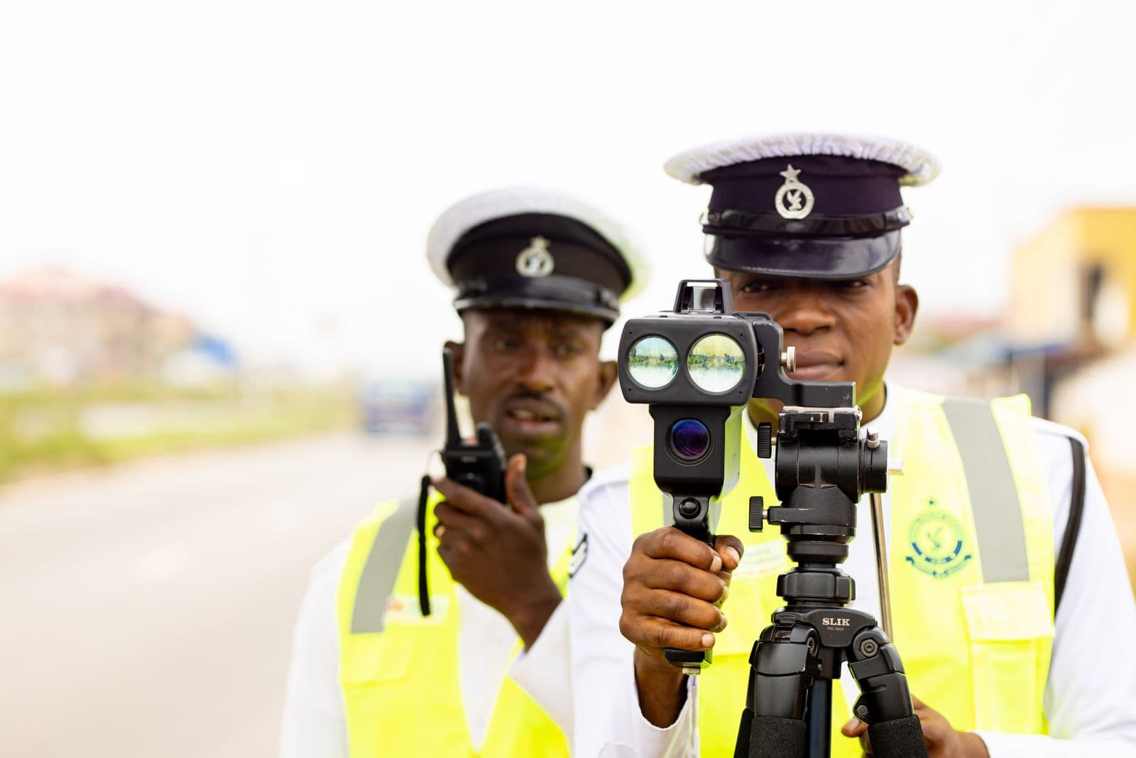Two officers using a speed camera on a tripod