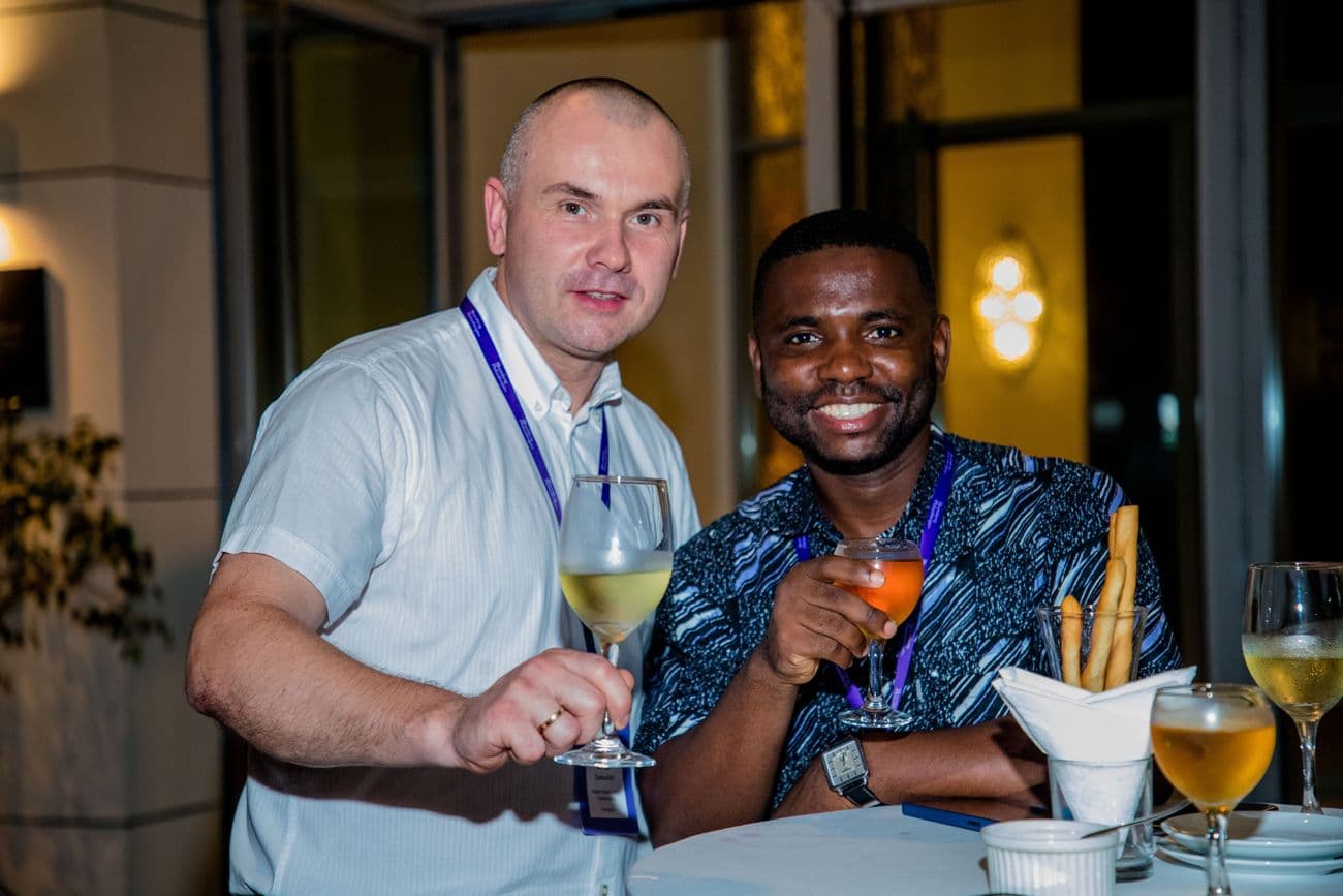 Two guests raising their glasses at a table